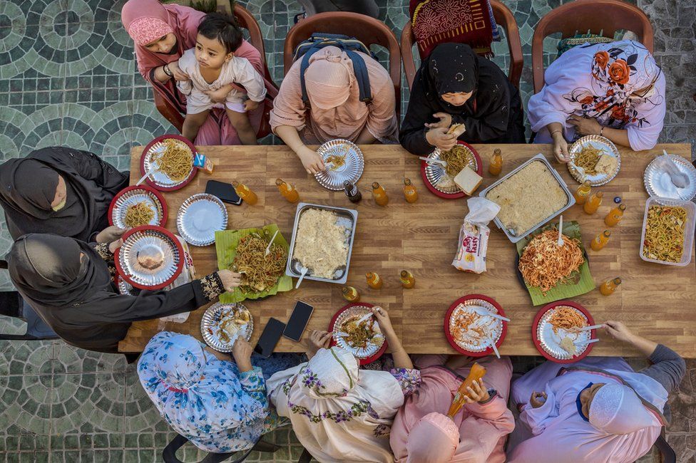 An aerial view of Muslims eating a meal together to celebrate Eid in the Garden Mosque in Taguig, Metro Manila, Philippines