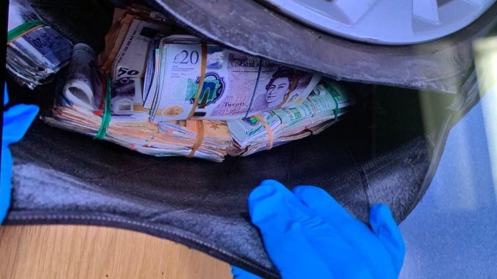Spare tyre opened to reveal bags of cash