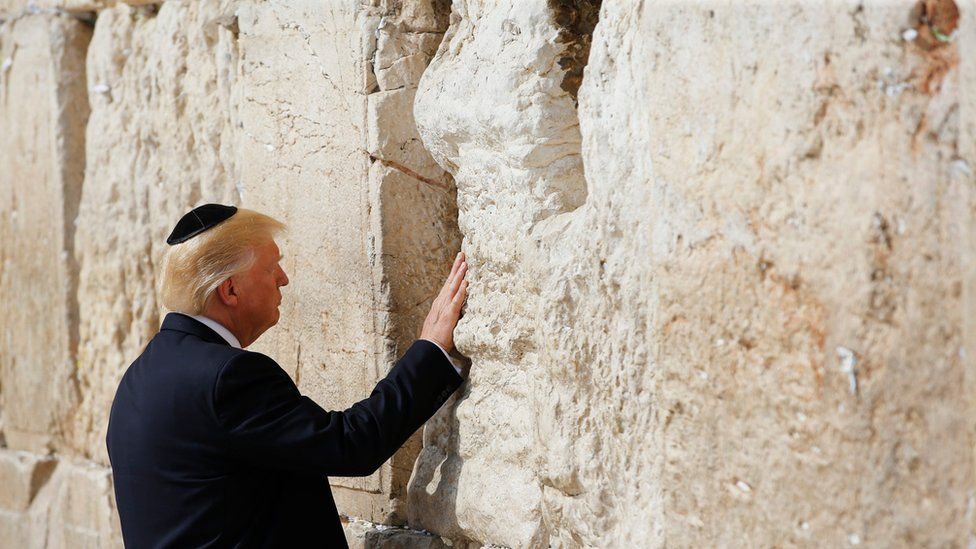 US President Donald Trump touches the Western Wall, Judaism's holiest prayer site, in Jerusalem's Old City