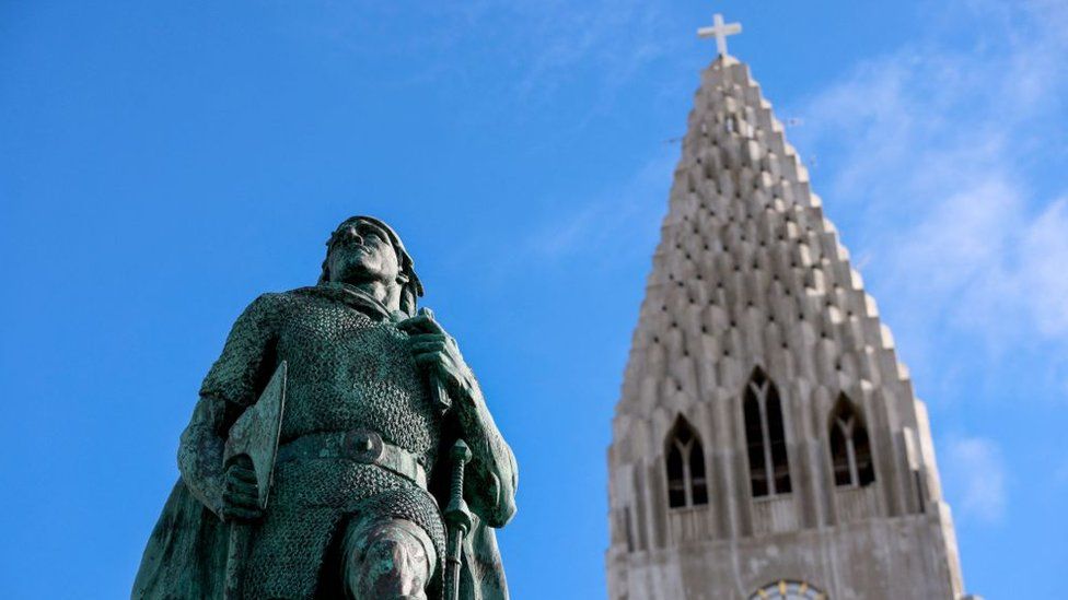 A statue of the Viking legend Leif Eriksson and the tower of the landmark Hallgrim church in Reykjavik