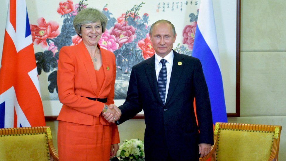 Theresa May shaking Vladimir Putin's hand