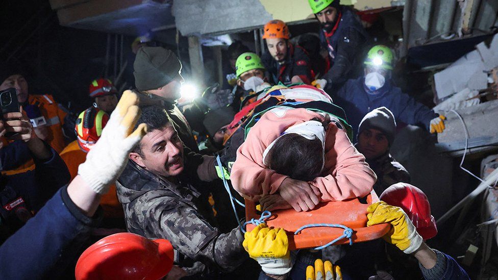 Person being carrying out of rubble on a stretcher