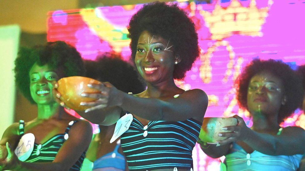 Miss Nappy contestants hold out bowls during the event in Abidjan, Ivory Coast - Saturday 16 November 2019