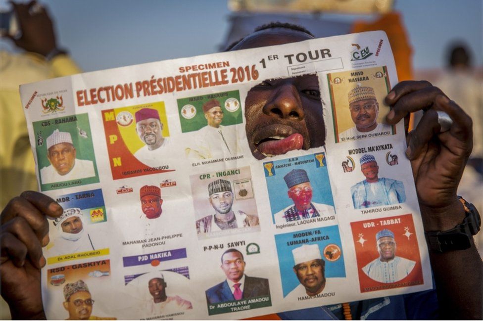 A photograph made available 20 February 2016 shows a supporter of main opposition candidate Hama Amadou who has ripped out the picture of incumbent president Issoufou Mahamadou in a specimen ballot paper during an election rally in Niamey, Niger 19 February 2016