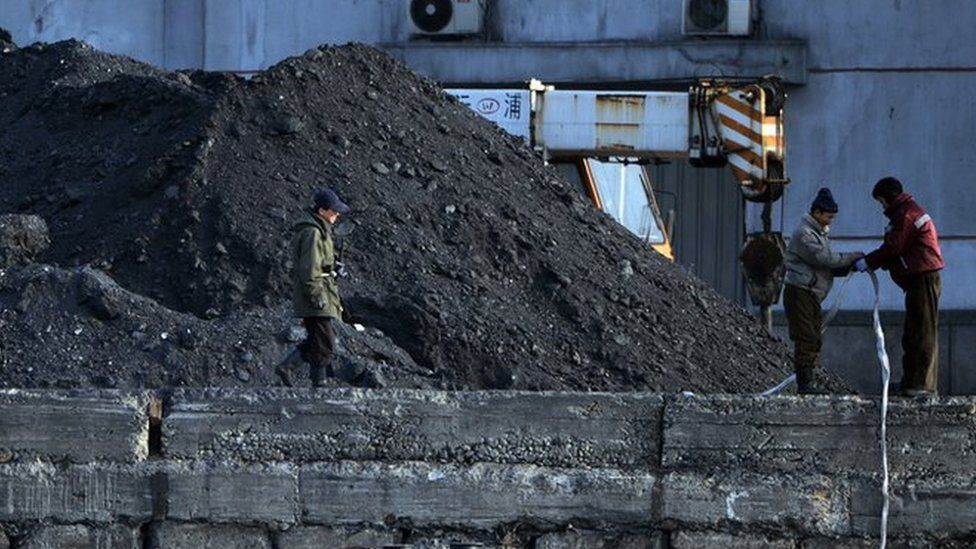 North Korean laborers work beside the Yalu River at the North Korean town of Sinuiju on 8 February 2013 which is close to the Chinese city of Dandong.