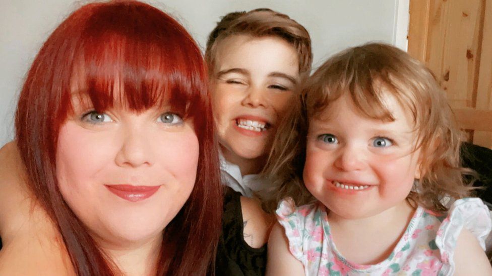 Family picture of Stacey, her son and daughter smiling