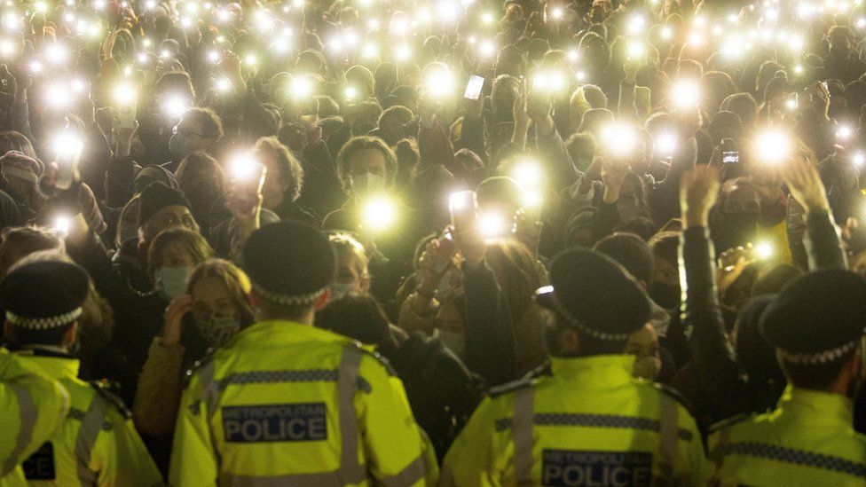 Police attend a vigil for Sarah Everard on Clapham Common in March 2021