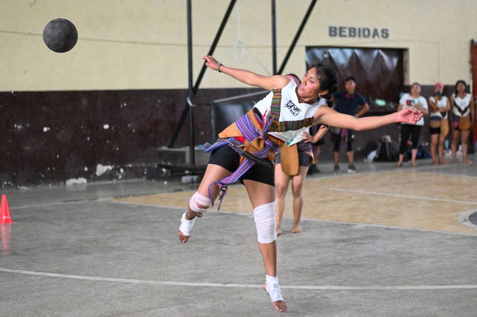 An indigenous woman kicks the ball during a Mayan ball game in Tecpan, Guatemala on March 23, 2024.