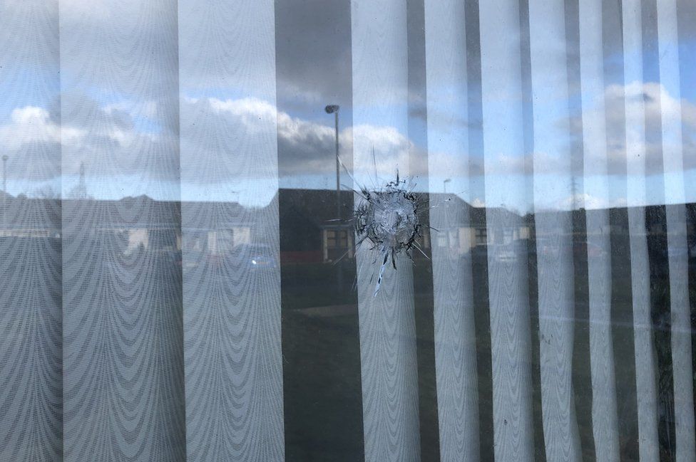 A bullet hole in the front window of a house at Oakvale Park in Coleraine