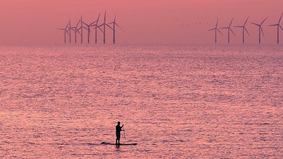 A paddleboarder is pictured on the water near Leasowe