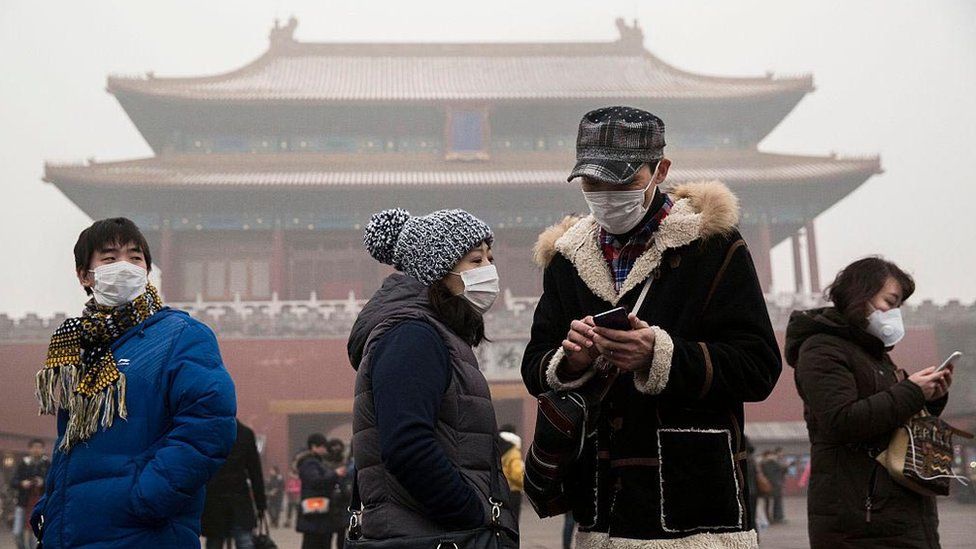 People wearing masks as protection from the pollution outside the Forbidden City