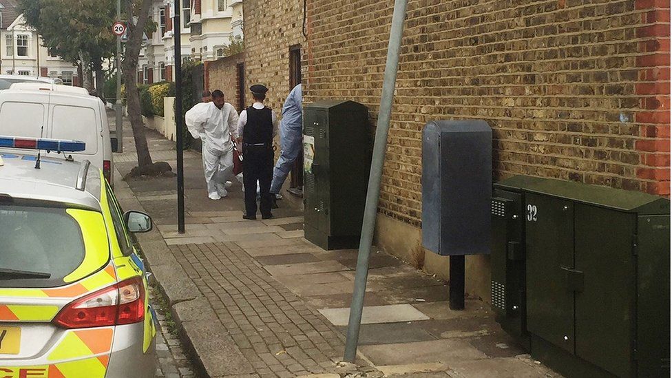 Forensic officers and police at the scene in Southfields