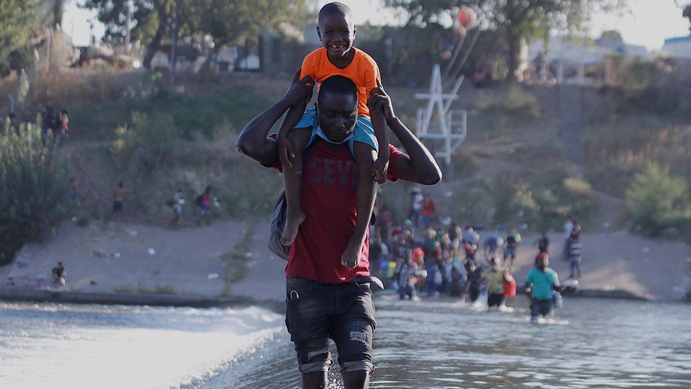 Migrants from Haiti cross the Rio Grande, on the border of Ciudad Acuna, Mexico, 17 September 2021