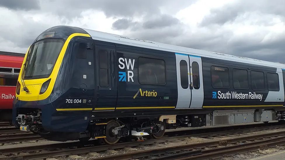 A new South Western Railway train in the sidings of a depot