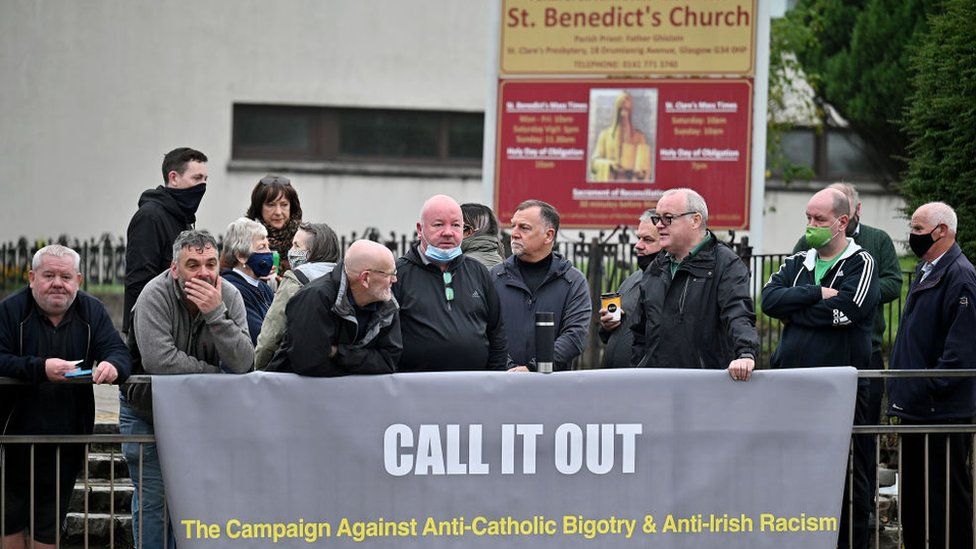 Supporters of Call It Out gathered outside St Benedict's Catholic church in Easterhouse as an Orange walk passed