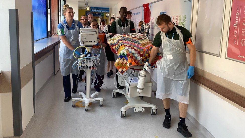 Baby being transferred to temporary neonatal unit