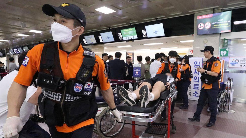 A passenger from the A321-200 Asiana Airlines flight on a stretcher at Daegu International Airport