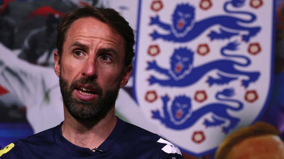 Gareth Southgate sitting in front of a Three Lions badge
