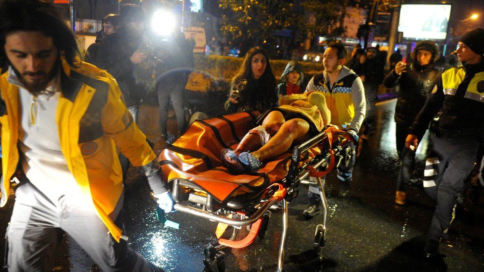 An injured woman is taken to an ambulance in Istanbul