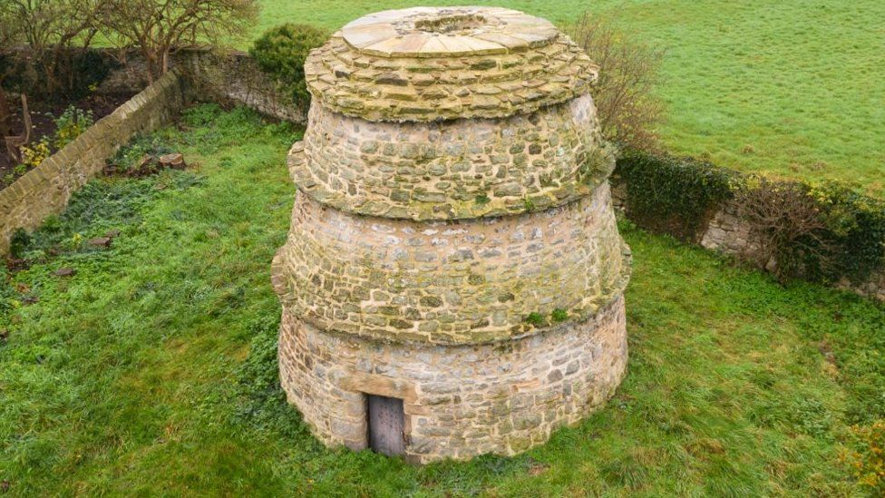 The dovecote, a tall round building