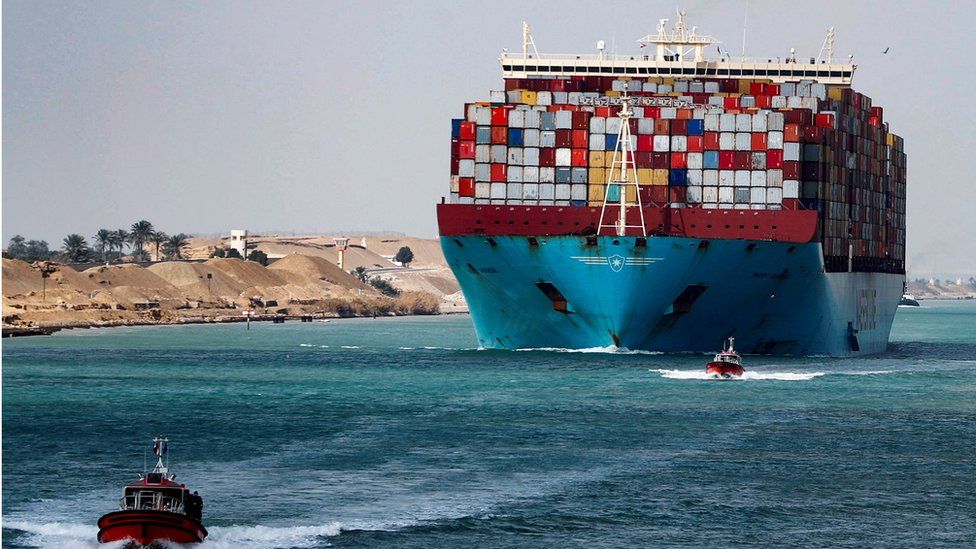 A shipping instrumentality  passes done  the Suez Canal successful  Suez, Egypt.