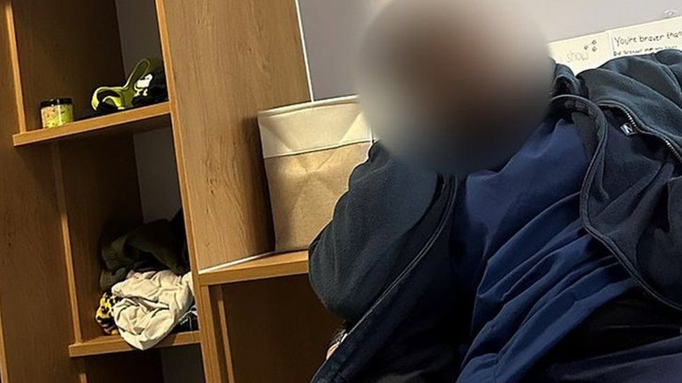 Blurred image of a mental health trust staff member apparently asleep on shift