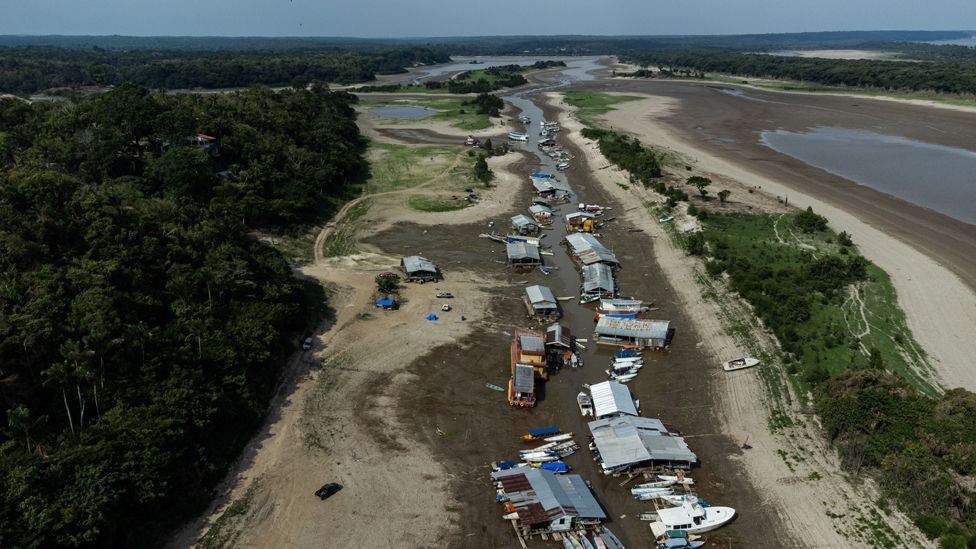 An aerial photograph taken by drone shows boats and houses stranded in a dried up area of Lago do Puraquequara lake, in Manaus, Amazonas, Brazil, 06 October 2023