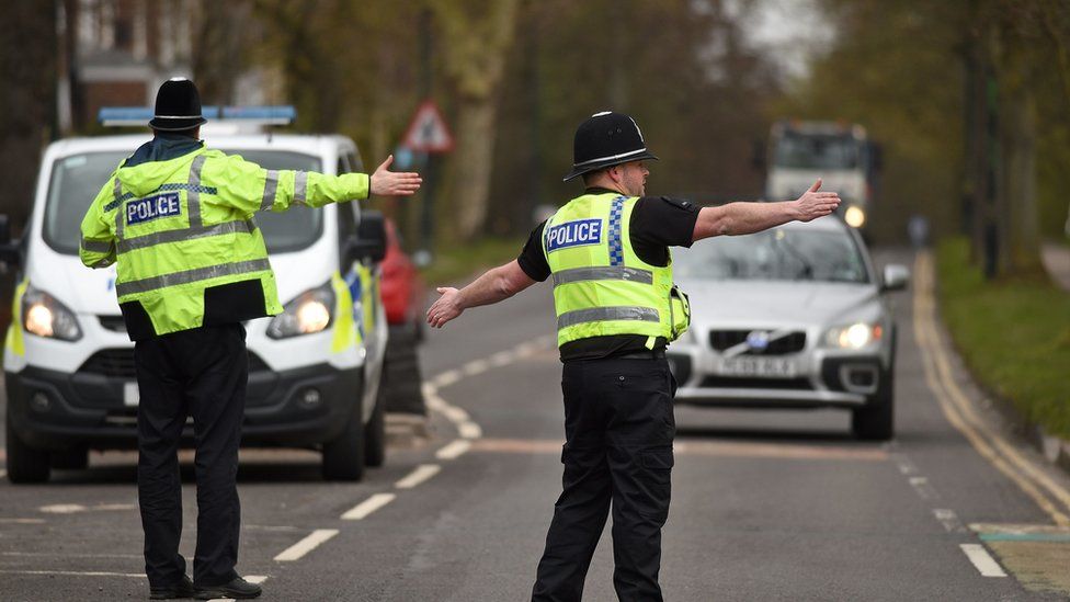 Police officers from North Yorkshire Police stop motorists in cars to check that their travel is "essential", in line with the British government's Covid-19 advice to "Stay at Home", in York, northern England