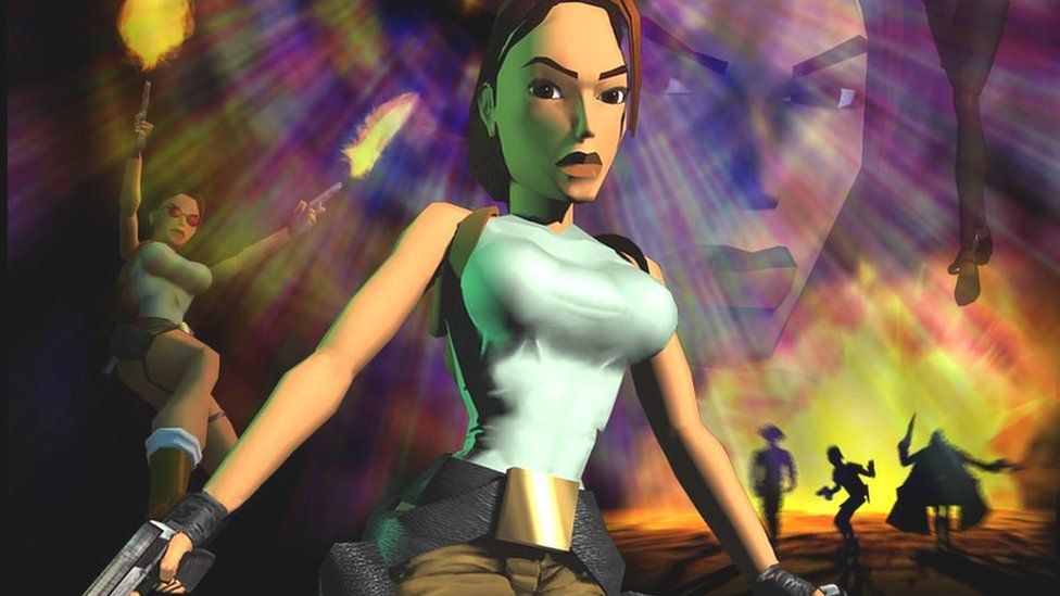 Lara Croft. Lara is a very blocky animation with brown hair, brown eyes, a blue crop top and exaggerated breasts. She holds a gun and wears a large utility belt.