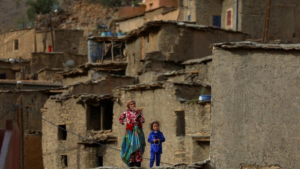 People affected by a deadly earthquake stand on a house, in the rural village of Azermoun, Morocco September 14, 2023