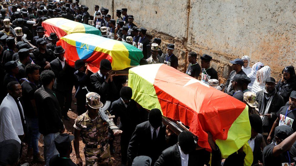 Mourners carry the coffin of Amhara president Ambachew Mekonnen and two other officials who where killed in an attack, during their funeral in the town of Bahir Dar, Amhara region