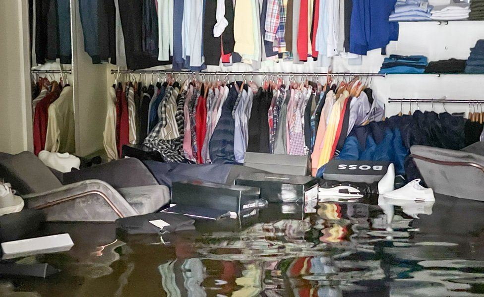 Clothing and furniture float on the floodwater in McCartan's men's clothing shop in Newry