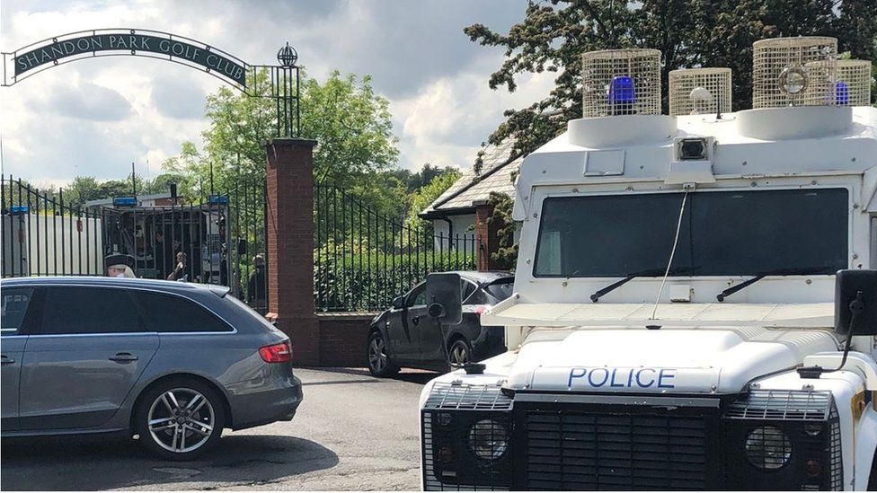 A Belfast golf club has been evacuated after a suspicious device was found under a car