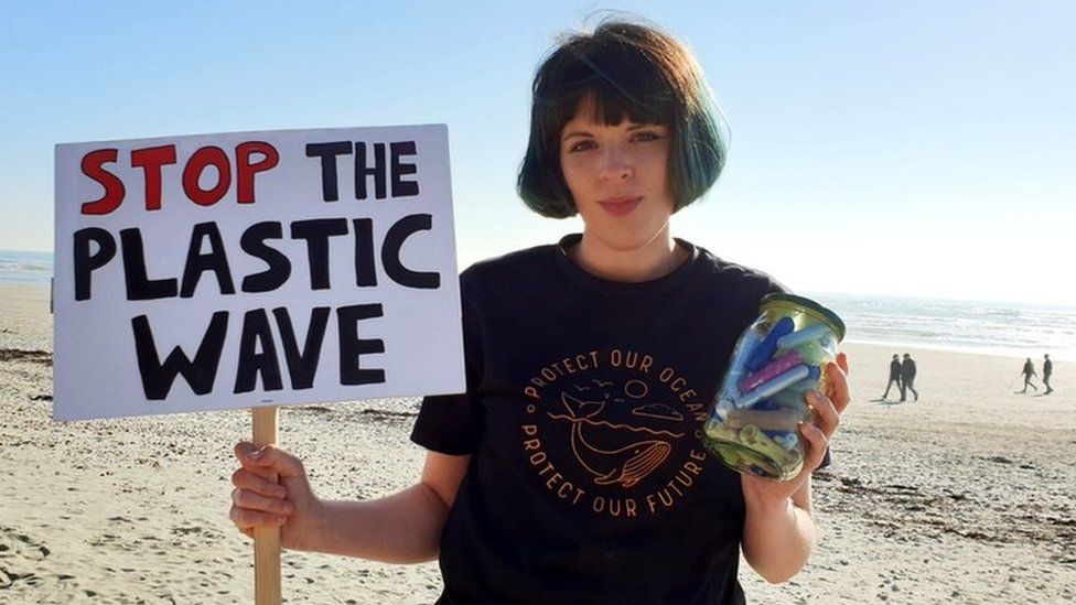 Ella Daish holding a 'stop the plastic wave' banner