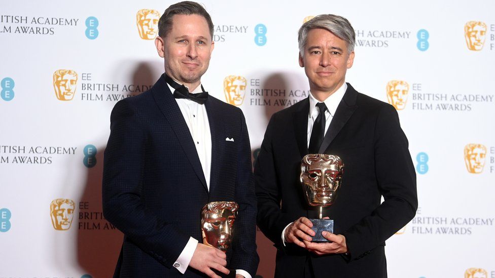 Elliot Graham (L) and Tom Cross (R), winners of the best editing award for No Downtime in Baftas