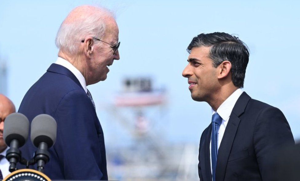 Joe Biden and Rishi Sunak shake hands