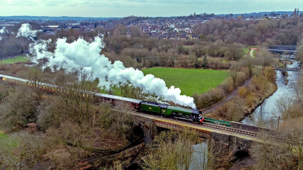 The Flying Scotsman, which is being operated by an all-female footplate team to mark International Women's Day, passes over the River Irwell at Ramsbottom, Greater Manchester.