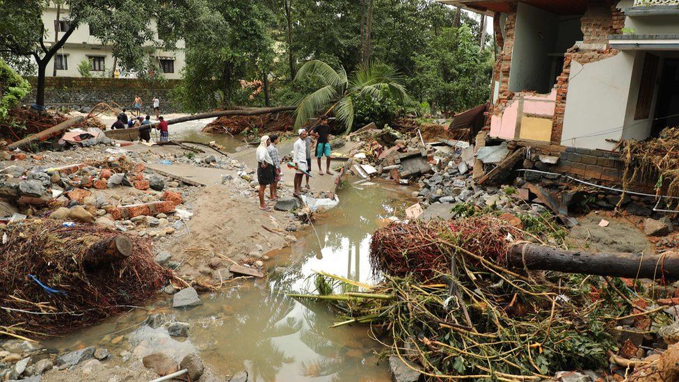 Residents in Kerala look at the devastation caused by flooding, August 2018