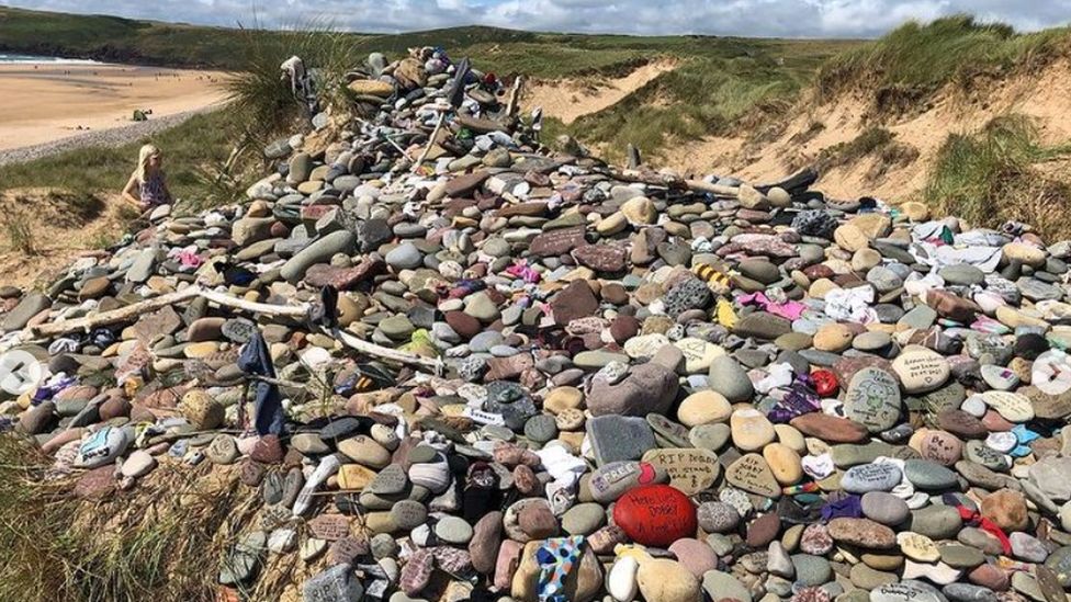 Stones and socks piled up at Dobby's grave