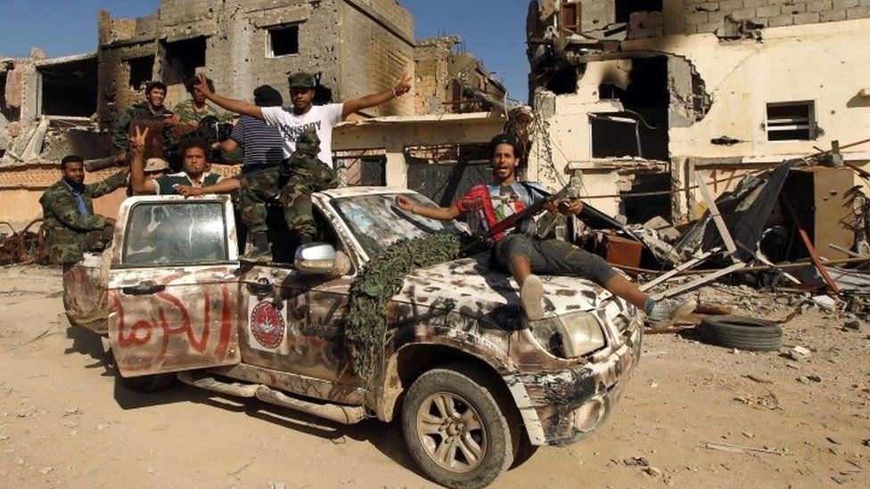 Fighters loyal to Libya's internationally recognised government celebrate in the street of Benghazi after taking control of Islamist areas (23 February 2016)
