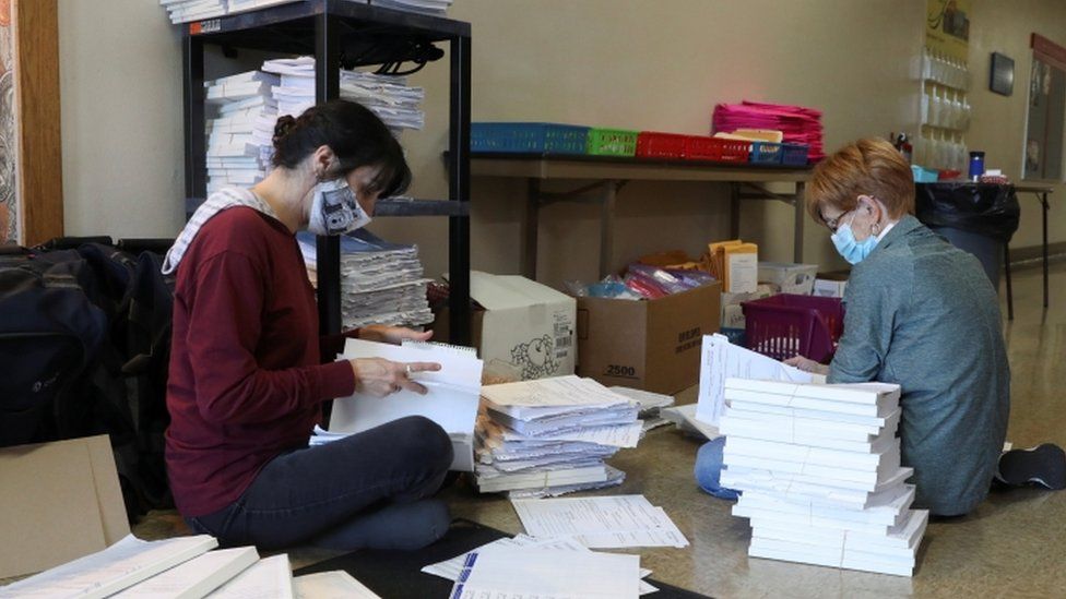 Election officians in Wisconsin sort voter signature books (4 November 2020)