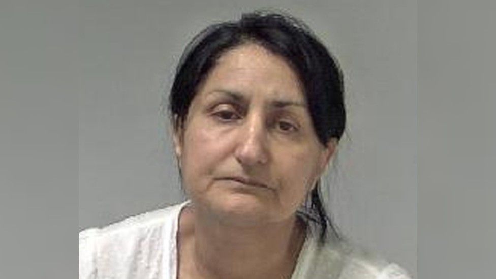 Police mugshot of Narinder Kaur, who is wearing a white top and has her hair tied back