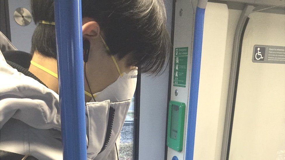 Man wearing mask on London commuter train