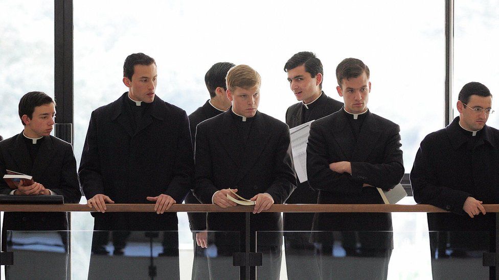 Priests and seminarists wait in the hall of the Regina Apostolorum pontifical university in Rome for the first lesson on exorcism, 17 February 2005