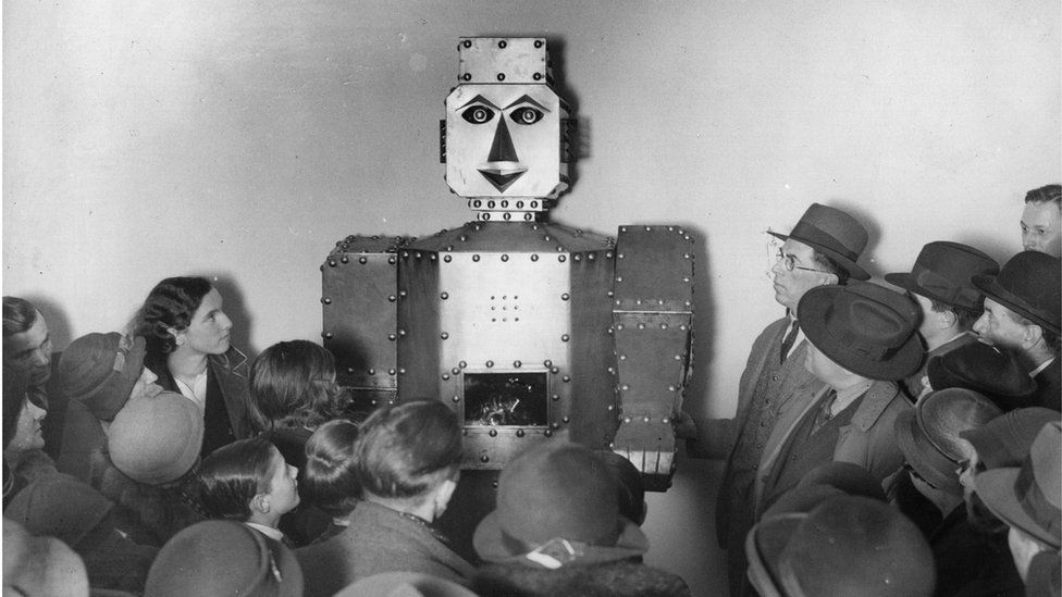 Children stand admiring a fortune-telling robot at Selfridges