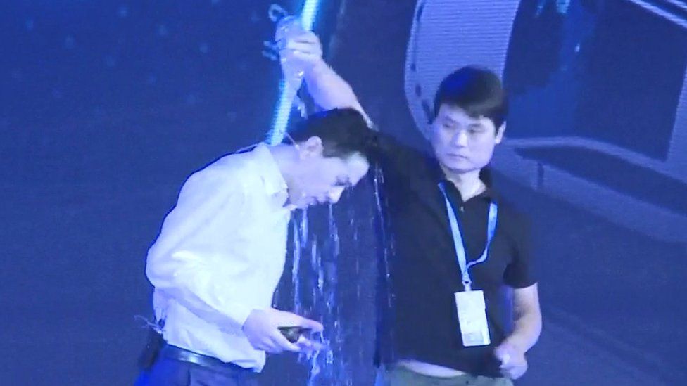 Baidu chief executive being doused with water from a bottle
