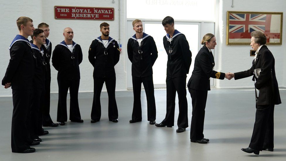 Princess Anne shakes a Navy personnel's hand