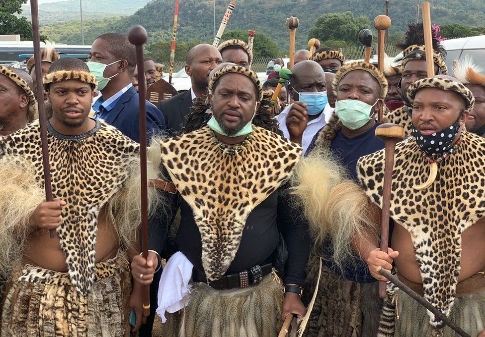 Men dressed in leopard hide according to custom