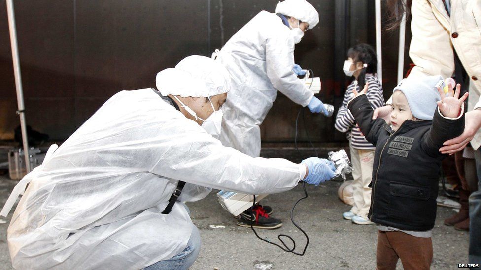 A Japanese boy is checked for the effects of radiation in the aftermath of a series of meltdowns at a nuclear plant in 2011