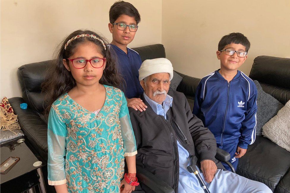 Mohammad at home with his grandchildren